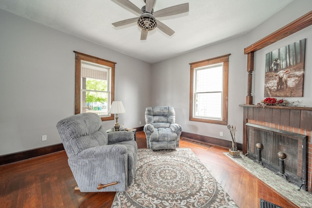 201 S 11th St, New Castle, IN 47362 - sitting room with a brick fireplace, wood finished floors, baseboards, and a ceiling fan