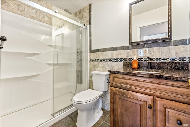 722 Biscayne Ave, Warsaw, IN 46580 - full bath featuring vanity, a shower stall, toilet, a wainscoted wall, and tile walls