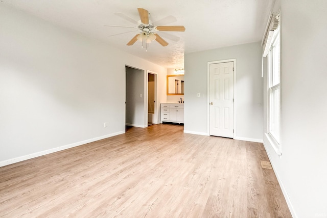 722 Biscayne Ave, Warsaw, IN 46580 - unfurnished bedroom with light wood-style floors, baseboards, and a ceiling fan