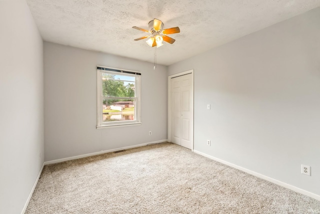 722 Biscayne Ave, Warsaw, IN 46580 - spare room featuring light colored carpet, baseboards, ceiling fan, and a textured ceiling