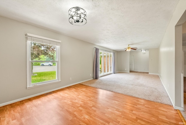 722 Biscayne Ave, Warsaw, IN 46580 - spare room with a textured ceiling, light wood finished floors, baseboards, and a ceiling fan