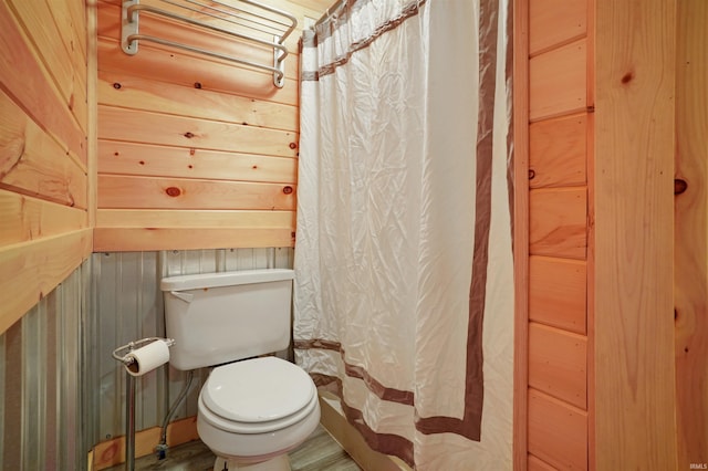 0 Creekview Ln, Cannelton, IN 47520 - full bathroom featuring toilet, a shower with shower curtain, and wooden walls