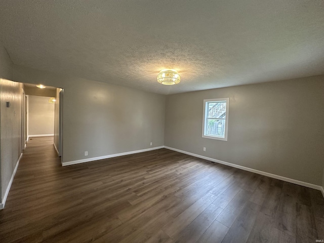 360 NE C St, Linton, IN 47441 - spare room with baseboards, dark wood finished floors, and a textured ceiling