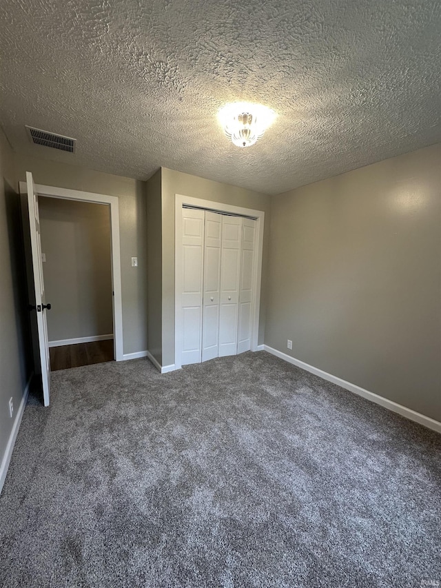 360 NE C St, Linton, IN 47441 - unfurnished bedroom with carpet floors, a closet, baseboards, and a textured ceiling