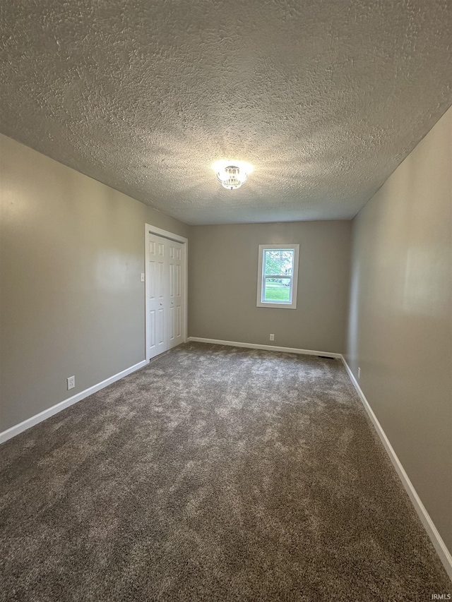 360 NE C St, Linton, IN 47441 - empty room featuring carpet, baseboards, and a textured ceiling