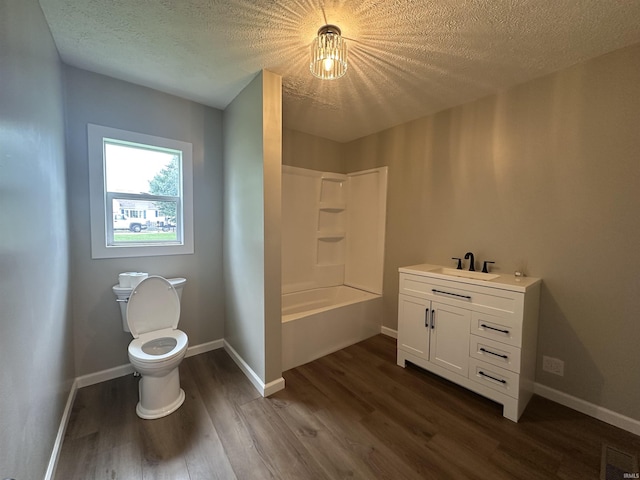 360 NE C St, Linton, IN 47441 - full bath featuring wood finished floors, toilet, a textured ceiling, vanity, and shower / washtub combination
