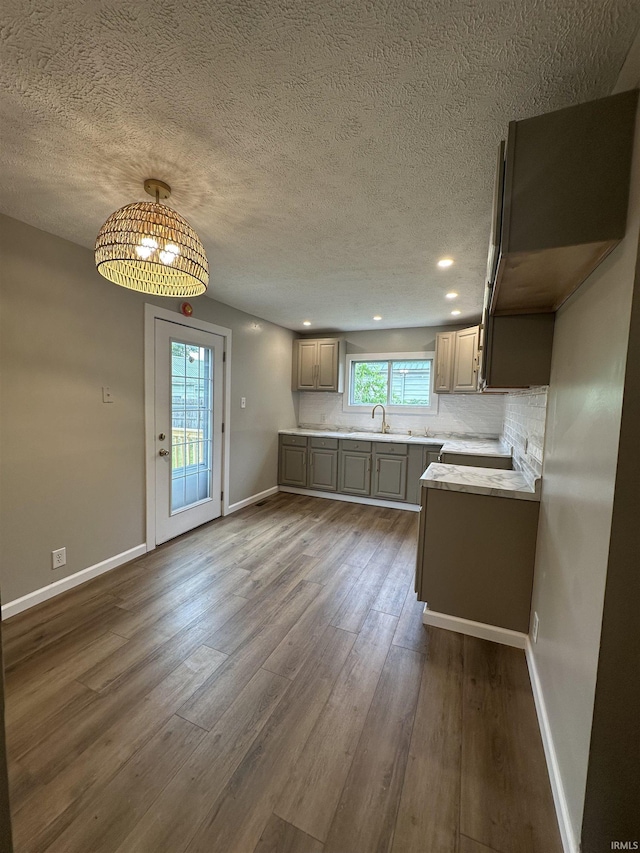 360 NE C St, Linton, IN 47441 - kitchen featuring a sink, a textured ceiling, baseboards, dark wood-type flooring, and light countertops
