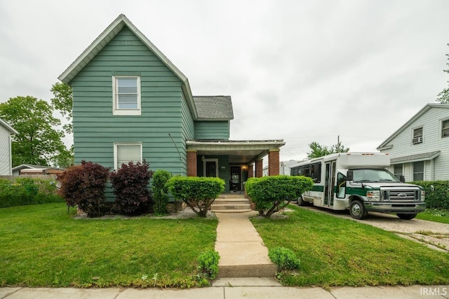 1226 Kinyon St, South Bend, IN 46616 - view of front of property featuring a front lawn, a porch, and a shingled roof