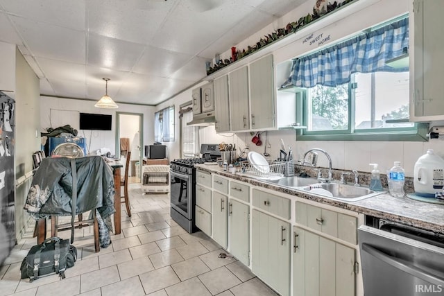 1226 Kinyon St, South Bend, IN 46616 - kitchen featuring appliances with stainless steel finishes, a sink, a paneled ceiling, light tile patterned floors, and under cabinet range hood