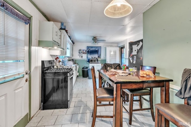 1226 Kinyon St, South Bend, IN 46616 - dining room featuring a ceiling fan, healthy amount of natural light, and light tile patterned floors