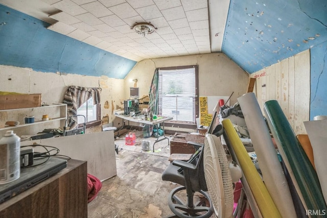 1226 Kinyon St, South Bend, IN 46616 - home office featuring lofted ceiling, carpet, and wood walls