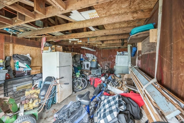 1226 Kinyon St, South Bend, IN 46616 - garage featuring freestanding refrigerator and wooden walls