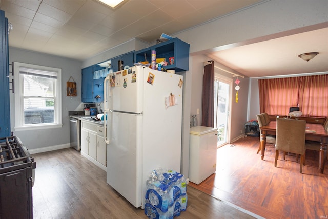 1310 Sinton Ave, Lafayette, IN 47905 - kitchen with freestanding refrigerator, black gas range, light wood-style flooring, and blue cabinets