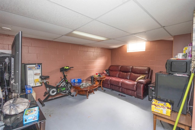 1310 Sinton Ave, Lafayette, IN 47905 - living room with concrete block wall, concrete flooring, and a drop ceiling
