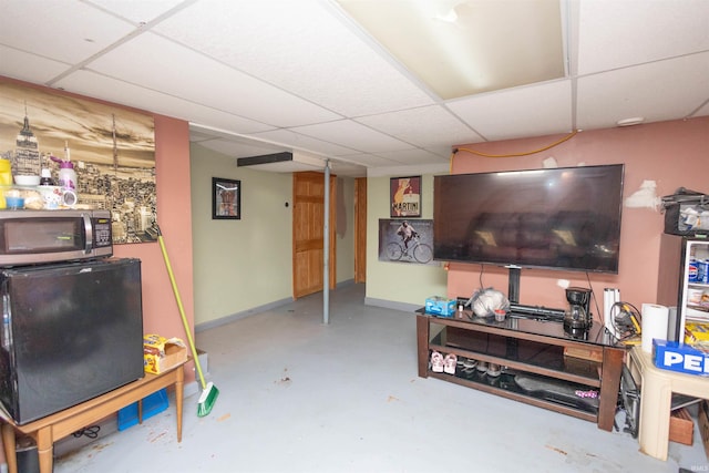 1310 Sinton Ave, Lafayette, IN 47905 - living area with a paneled ceiling, finished concrete flooring, and baseboards