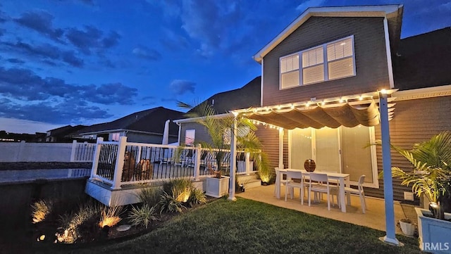 13224 Prairie Dr, Evansville, IN 47725 - back of house at twilight featuring a wooden deck, a patio area, and a pergola