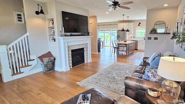 13224 Prairie Dr, Evansville, IN 47725 - living area featuring a ceiling fan, light wood-style floors, a fireplace, recessed lighting, and built in features