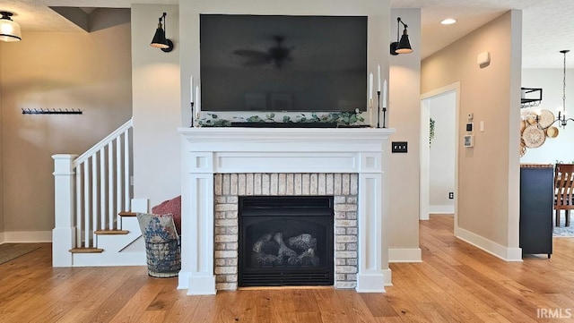 13224 Prairie Dr, Evansville, IN 47725 - detailed view of wood finished floors, baseboards, a brick fireplace, and recessed lighting
