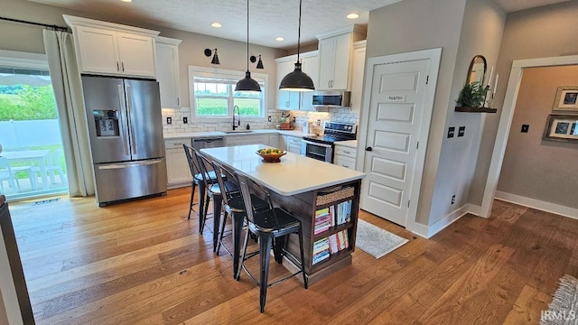 13224 Prairie Dr, Evansville, IN 47725 - kitchen featuring stainless steel appliances, white cabinetry, backsplash, light countertops, and recessed lighting