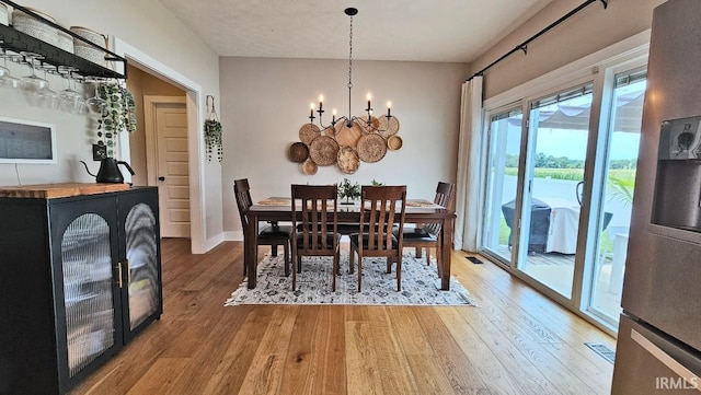 13224 Prairie Dr, Evansville, IN 47725 - dining room featuring wood finished floors, a chandelier, and baseboards
