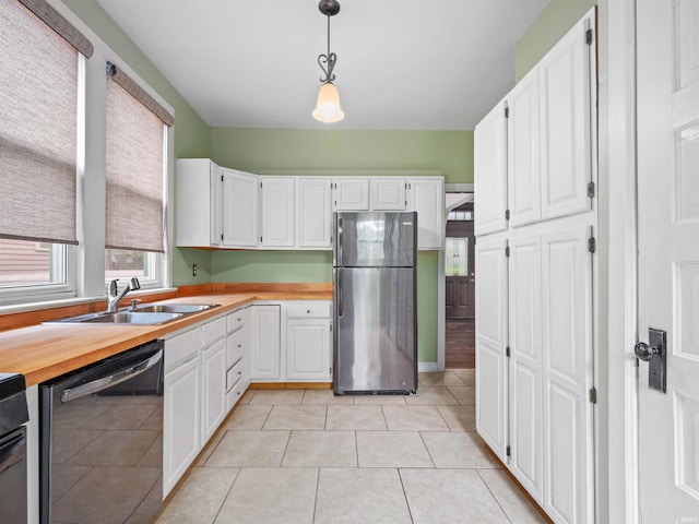 336 Arcadia Ct, Fort Wayne, IN 46807 - kitchen with appliances with stainless steel finishes, a sink, white cabinetry, decorative light fixtures, and light tile patterned floors