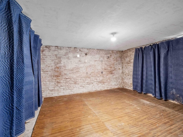 336 Arcadia Ct, Fort Wayne, IN 46807 - spare room with brick wall and wood finished floors