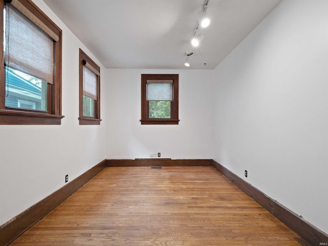 336 Arcadia Ct, Fort Wayne, IN 46807 - unfurnished room with plenty of natural light, light wood-type flooring, baseboards, and track lighting
