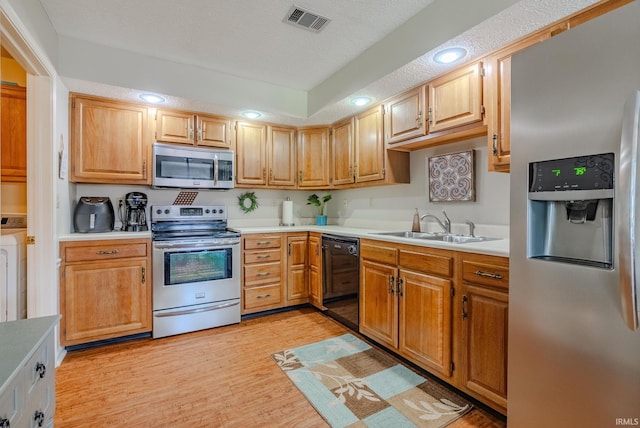 4635 S Bellamy Blvd, Marion, IN 46953 - kitchen featuring stainless steel appliances, light countertops, light wood-type flooring, recessed lighting, and washer / dryer
