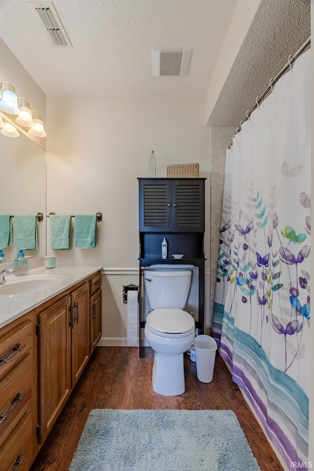 4635 S Bellamy Blvd, Marion, IN 46953 - full bathroom featuring vanity, wood finished floors, a textured ceiling, and curtained shower