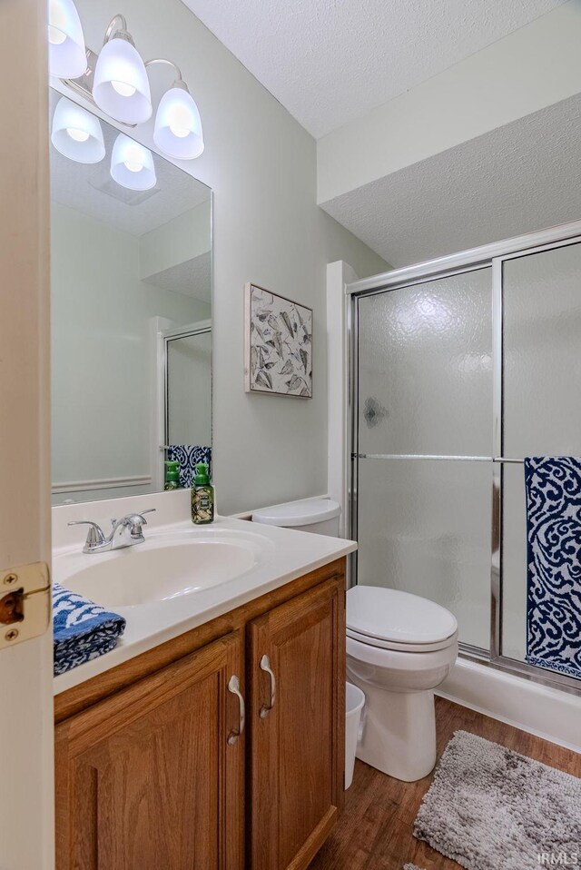 4635 S Bellamy Blvd, Marion, IN 46953 - bathroom featuring wood finished floors, vanity, a shower stall, and a textured ceiling