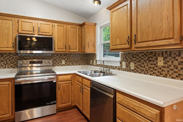 3316 Ingram Ct, Lafayette, IN 47906 - kitchen with stainless steel appliances, a sink, vaulted ceiling, dark wood-type flooring, and light countertops