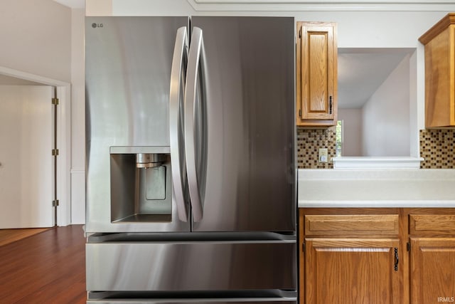 3316 Ingram Ct, Lafayette, IN 47906 - kitchen featuring stainless steel fridge with ice dispenser, decorative backsplash, light countertops, brown cabinetry, and wood finished floors