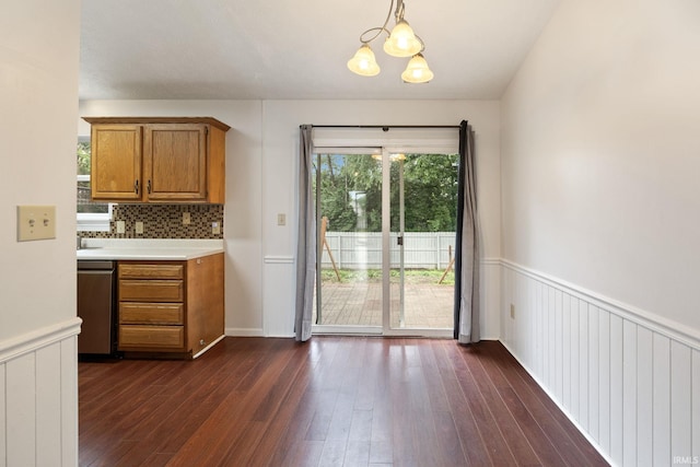 3316 Ingram Ct, Lafayette, IN 47906 - kitchen with stainless steel dishwasher, brown cabinetry, a chandelier, light countertops, and dark wood-type flooring