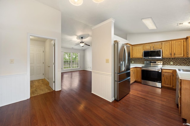 3316 Ingram Ct, Lafayette, IN 47906 - kitchen with appliances with stainless steel finishes, vaulted ceiling, a ceiling fan, dark wood-style flooring, and wainscoting
