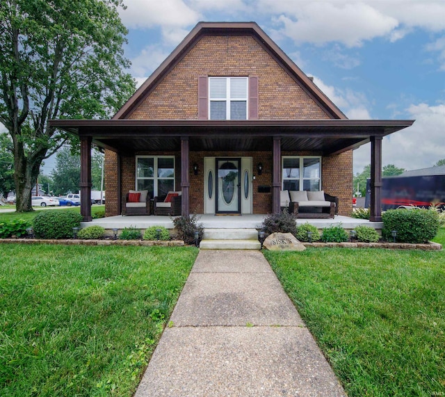 409 E Strain St, Fort Branch, IN 47648 - view of front of property with brick siding, a porch, and a front lawn