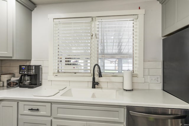 409 E Strain St, Fort Branch, IN 47648 - kitchen featuring dishwasher, a sink, backsplash, and light countertops