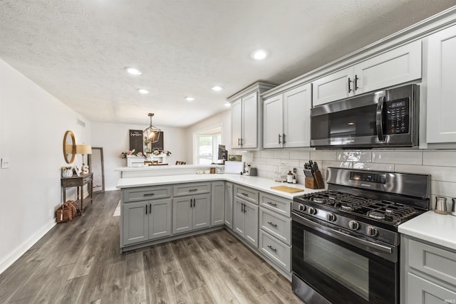 409 E Strain St, Fort Branch, IN 47648 - kitchen with stainless steel microwave, gas range oven, gray cabinetry, a peninsula, and light countertops