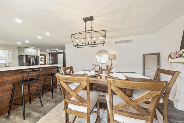 409 E Strain St, Fort Branch, IN 47648 - dining room featuring a barn door, wood finished floors, and recessed lighting