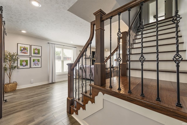 409 E Strain St, Fort Branch, IN 47648 - stairs featuring a textured ceiling, baseboards, wood finished floors, and recessed lighting
