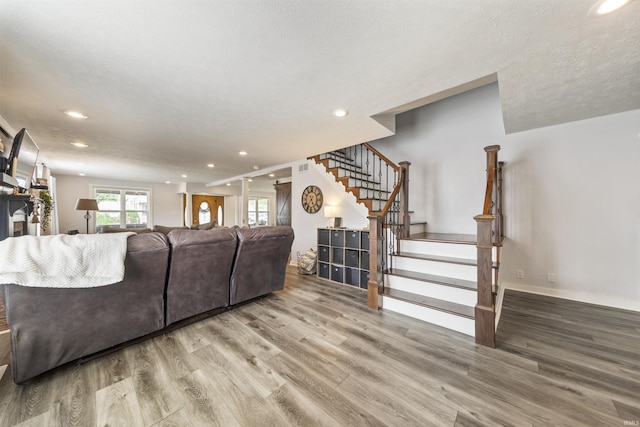 409 E Strain St, Fort Branch, IN 47648 - living area featuring recessed lighting, stairway, wood finished floors, and baseboards