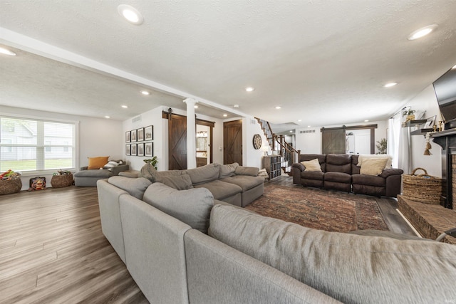 409 E Strain St, Fort Branch, IN 47648 - living room with recessed lighting, a barn door, wood finished floors, and stairway