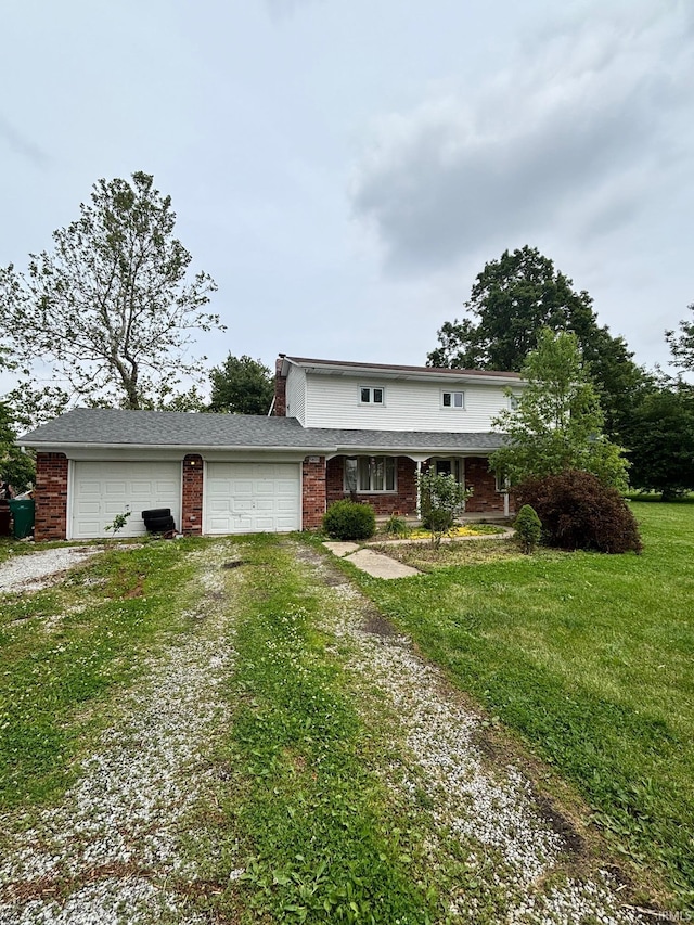 5800 W 100 N Rd, Tipton, IN 46072 - traditional home featuring dirt driveway, an attached garage, brick siding, and a front yard