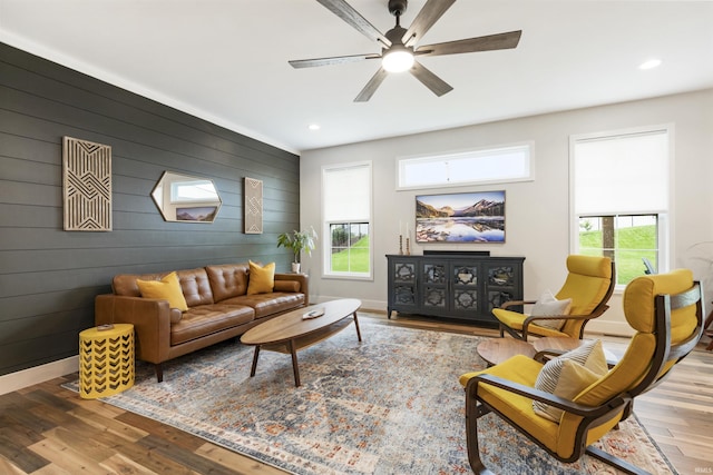 1215 Ladbrooke Dr, Evansville, IN 47725 - living room featuring healthy amount of natural light, a ceiling fan, wood finished floors, recessed lighting, and wooden walls