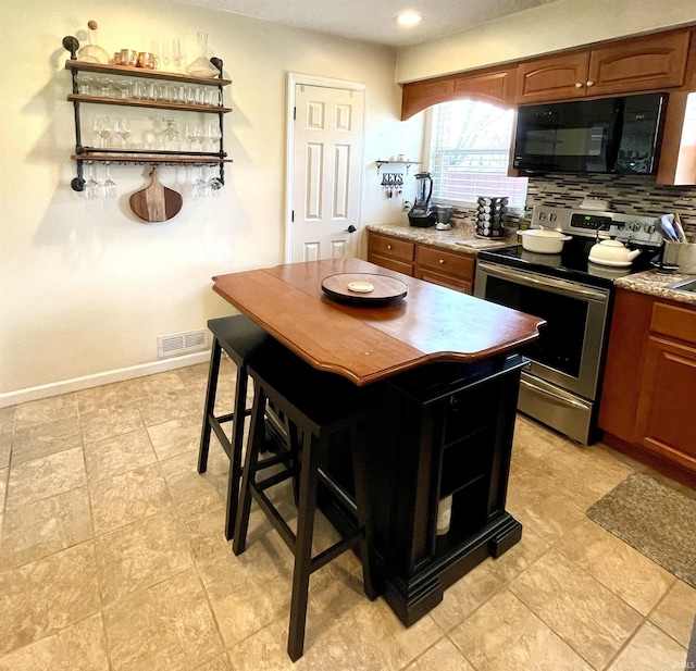 1741 Rockne Dr, South Bend, IN 46617 - kitchen featuring stainless steel electric stove, black microwave, open shelves, tasteful backsplash, and recessed lighting