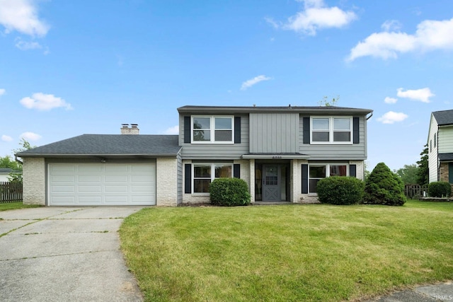 6320 Wakopa Ct, Fort Wayne, IN 46815 - traditional-style home with concrete driveway, a garage, brick siding, and a chimney