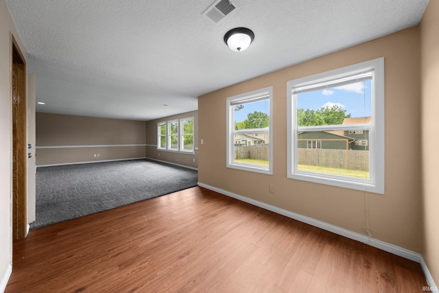 6320 Wakopa Ct, Fort Wayne, IN 46815 - unfurnished room featuring wood finished floors, baseboards, and a textured ceiling