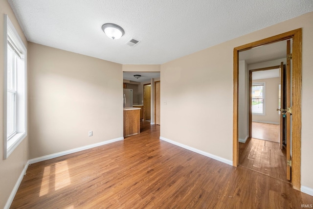 6320 Wakopa Ct, Fort Wayne, IN 46815 - unfurnished room featuring wood finished floors, baseboards, and a textured ceiling