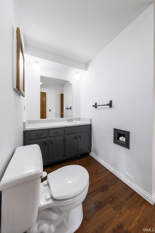 6320 Wakopa Ct, Fort Wayne, IN 46815 - half bath with toilet, wood finished floors, vanity, and baseboards
