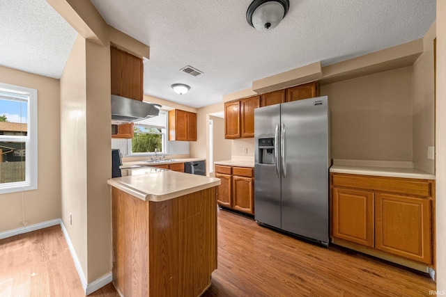 6320 Wakopa Ct, Fort Wayne, IN 46815 - kitchen with stainless steel refrigerator with ice dispenser, light wood-style flooring, a textured ceiling, light countertops, and brown cabinetry