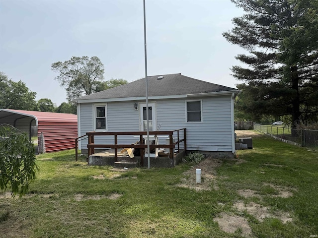 51930 County Road 9, Elkhart, IN 46514 - back of property with a shingled roof, central air condition unit, a carport, and a wooden deck